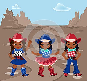 Three girls cowboy on the background of rocky desert.