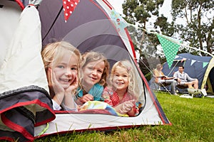 Three Girls Enjoying Camping Holiday On Campsite