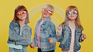 Three girls friends wearing sunglasses listening music, dancing disco fooling around having fun
