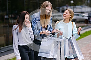Three girls go with purchases from the store