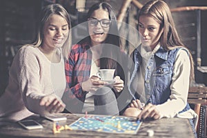 Three girls having fun and playing game.