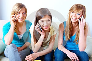 Three girls with mobile phones