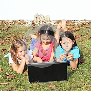 Three girls playing with notebook