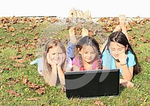 Three girls playing with notebook