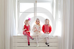 Three girls in red and white clothes window