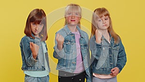 Three girls siblings trying to fight at camera, shaking fist, boxing with expression, punishment