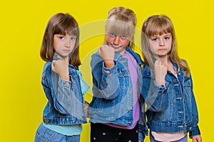 Three girls siblings trying to fight at camera, shaking fist, boxing with expression, punishment