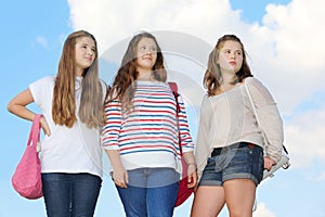 Three girls stand together