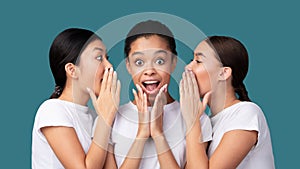 Three Girls Whispering Secret News Standing On Turquoise Background, Panorama