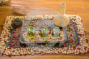 Three glass bottles with aromatic oils and spice on the wooden table