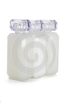 Three glass bottles of toiletries