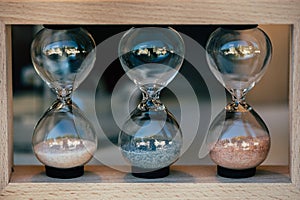 Three glass hourglasses with retro look