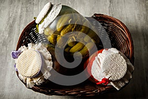 three glass jars with homemade canned vegetables lie in basket