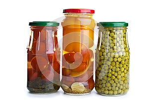 Three glass jars with marinated vegetables