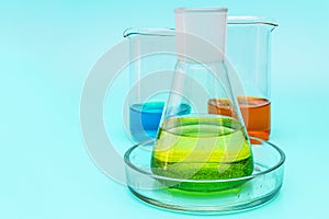 Three glass laboratory flasks with solutions of different colors. The concept of medical and chemical experiments and research.