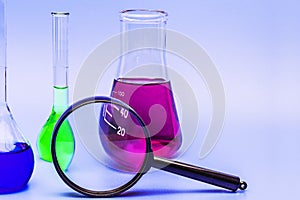Three glass laboratory flasks with solutions in different colors. The concept of medical and chemical experiments and research.