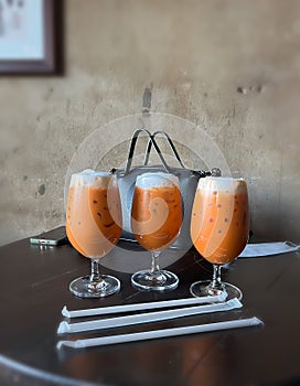 Three glass of Milk Tea on table in tearoom after long work hours