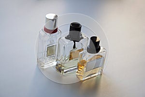 Three glass perfume bottles on white background