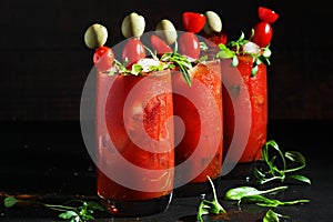 Three glasses with Bloody Mary cocktail