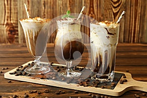 Three glasses of different cold coffee drinks.