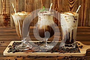 Three glasses of different cold coffee drinks.