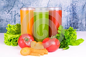 Three glasses with fresh vegetable juices. Close-up.