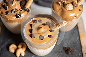 Three glasses Iced Dalgona Coffee, a trendy fluffy creamy whipped coffee