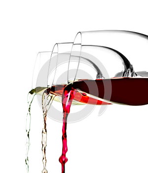 Three glasses of red, white and pink wine are poured