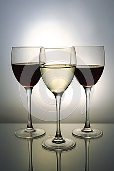 Three glasses with red and white wine