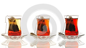 three glasses of Turkish tea in comparison from light to dark