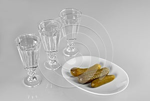 Three glasses of vodka with snack