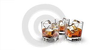 Three glasses of whiskey with ice cubes isolated on a white background.