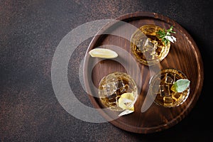 Three glasses of whiskey served in rocks.