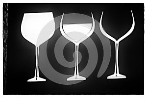 Three glasses of wine on a black background