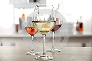 Three glasses with wine on kitchen table