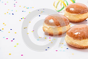 Three Glazed doughnuts with konfetti and streamers photo