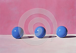 Three Glossy Blue Spheres on Pink Textured Background