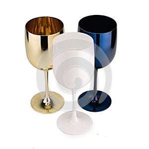 Three glossy plastic blue, white and golden Wineglass  for gourmets. Isolated glass cup on white background photo