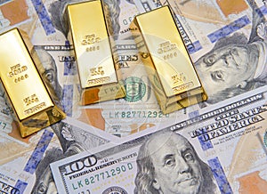Three gold bar with new american hundred dollar bills