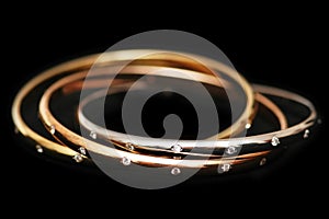 Three gold bracelets isolated