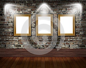 Three gold frames on brick wall
