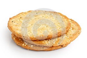 Three golden cheese crackers on white