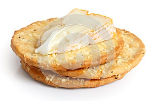 Three golden cheese crackers on white.