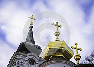 Three golden crosses on an orthodox church against blue sky