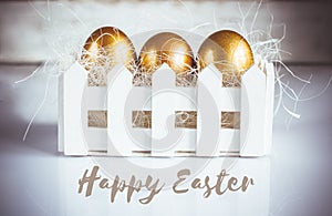 Three golden easter eggs on white background