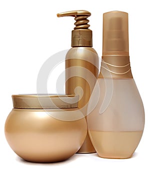 Three Golden plastic jars and bottles isolated on