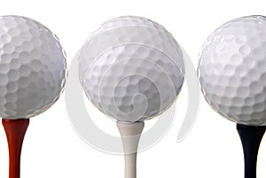 Three golf balls on tees