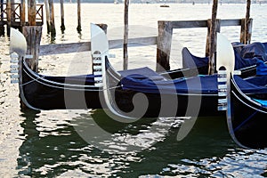 Three gondola boats moored in Grand Canal in Venice, Italy