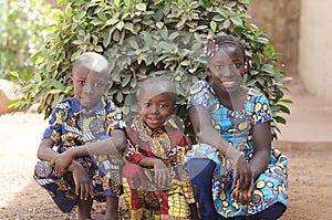 Three gorgeous African children posing outdoors Smiling and Laughing