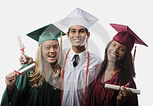 Three graduates in cap and gown